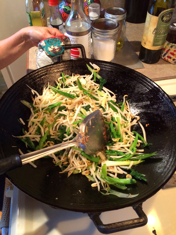 3. Lightly stir fry bean sprouts, scallions and rappini. 