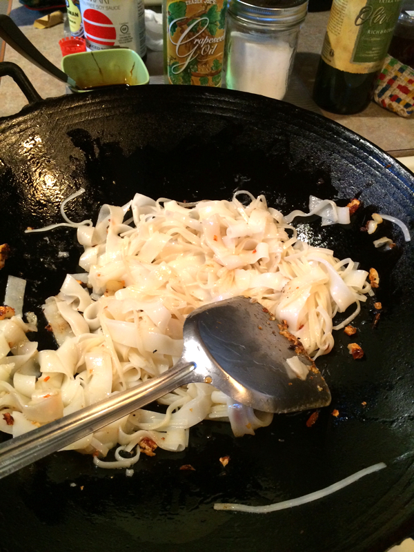 5. Fry chilies and garlic, then add in one portion of rice noodles.