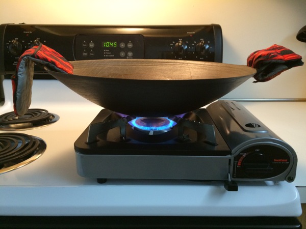 This Iwatani, 12,000 BTU portable gas burner is PERFECT for the 15 1/2 " cast iron wok. The heat is focused at the base where it's needed most.  I leave it sitting on top of my electric coil burner all the time so it's convenient so I end up using it for cooking most everything. This helps to build patina faster.  