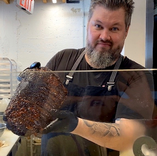 Chef Richard Hales show off a rack of Beef Ribs.