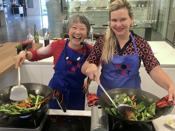 Eleanor Hoh, Dr. Nancy Richmond have fun stir frying in a cooking class